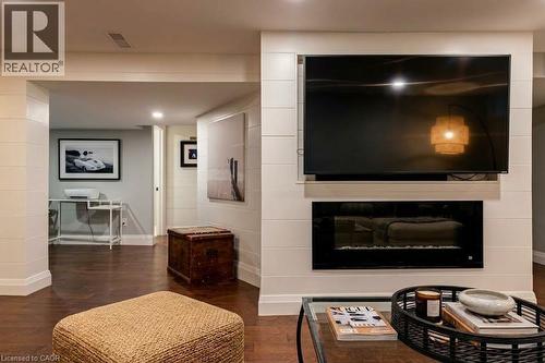 Wood-finish flooring, recessed lighting, and white shiplap accent walls - 896 Eagle Drive, Burlington, ON 