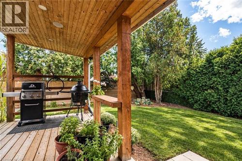 Covered wood-plank deck with recessed lighting, wood-plank ceiling, and wood railings - 896 Eagle Drive, Burlington, ON 