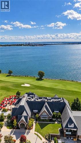 Expansive water body, verdant golf course, brick exterior, dark shingle roof, and manicured landscaping - 896 Eagle Drive, Burlington, ON 