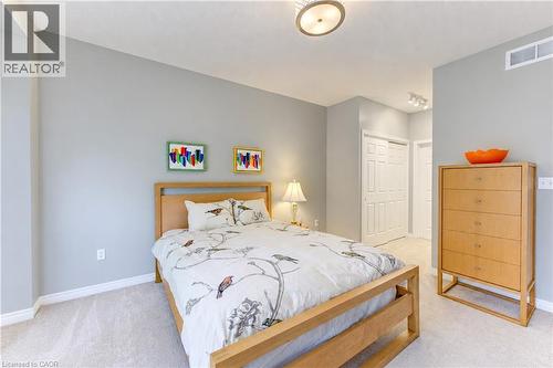 Main floor primary bedroom with his & her closets. - 222 Chestnut Hill Crescent, Kitchener, ON 