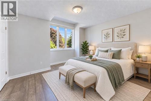 Wood-finish flooring, white trim, and a window with exterior views - 365 Woolwich Street, Waterloo, ON 