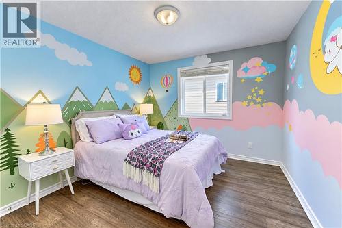 Wood-finish flooring with white baseboards, recessed window, and flush mount lighting - 365 Woolwich Street, Waterloo, ON 