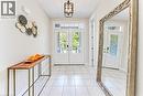 Entryway featuring twin paneled doors with transom windows, a grid-patterned ceiling light fixture, and large square tile flooring - 365 Woolwich Street, Waterloo, ON 