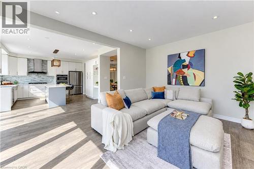 Recessed lighting throughout, wood-finish flooring, and white kitchen cabinetry - 365 Woolwich Street, Waterloo, ON 