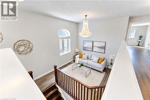 Vaulted ceiling with an ornate chandelier, arched window, and wood-finish flooring - 365 Woolwich Street, Waterloo, ON 