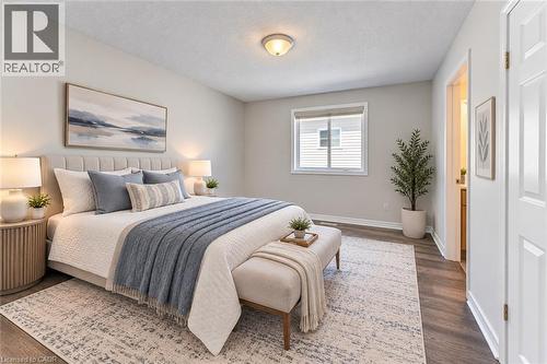Wood-finish flooring throughout, bright white trim, and a window with blinds - 365 Woolwich Street, Waterloo, ON 