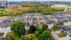 Aerial perspective of a developed residential neighborhood with structured streets, established homes, and mature landscaping - 