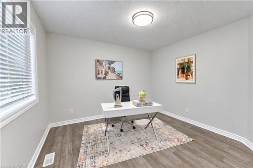 Neutral wall paint, wood-finish flooring, and a flush mount ceiling light - 365 Woolwich Street, Waterloo, ON 
