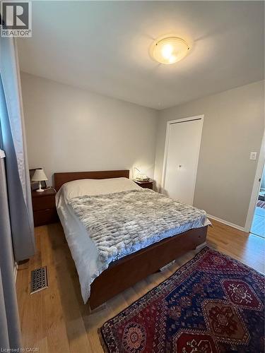 Light wood-finish flooring with a flush-mount ceiling light - 281 Toll Gate Boulevard, Waterloo, ON 