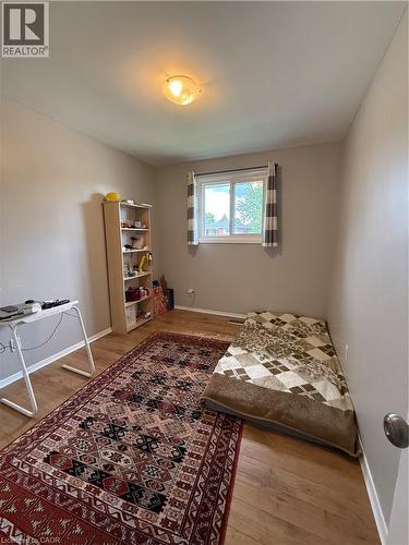 Wood-finish flooring, a single window, and a flush mount light fixture - 281 Toll Gate Boulevard, Waterloo, ON 