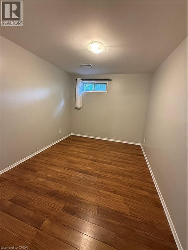 Wood-finish flooring, neutral wall tones, recessed window, and flush mount lighting - 281 Toll Gate Boulevard, Waterloo, ON 