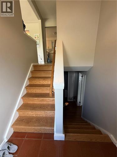 Wood-finish stairs with white risers and a wood handrail - 281 Toll Gate Boulevard, Waterloo, ON 