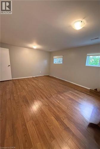 Wood-finish flooring throughout, neutral painted walls, and overhead flush-mount lighting - 281 Toll Gate Boulevard, Waterloo, ON 