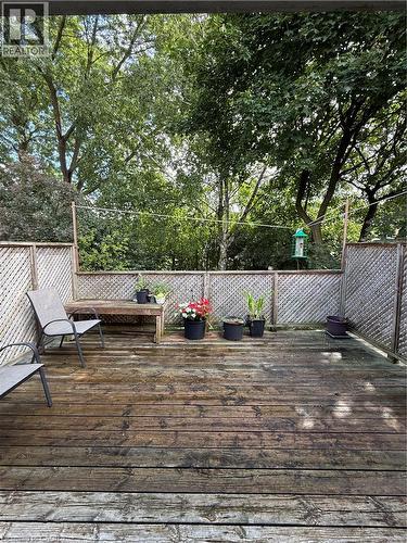 Expansive wood deck with lattice privacy fencing and mature surrounding trees - 281 Toll Gate Boulevard, Waterloo, ON 