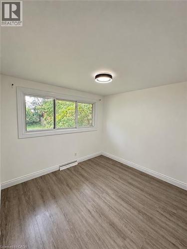 Wood-finish flooring, white walls, and a contemporary ceiling light fixture - 84 Weber Street S, Waterloo, ON 