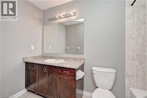 Dark wood-finish vanity with a built-in sink and countertop - 103 Blackbird Circle, Cambridge, ON 