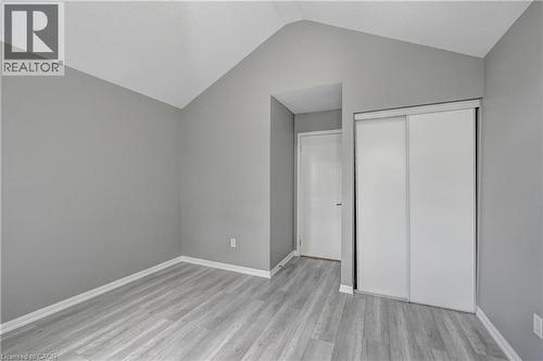 Vaulted ceiling accentuates this space featuring wood-finish flooring - 103 Blackbird Circle, Cambridge, ON 