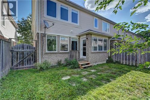 Rear exterior featuring a bay window, a rear entry door, and stone and siding facade - 103 Blackbird Circle, Cambridge, ON 