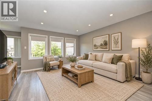 Recessed lighting, wood-finish flooring, and multiple windows with roller shades - 103 Blackbird Circle, Cambridge, ON 