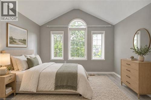 Vaulted ceiling, arched window, two additional large windows, wood-finish flooring, light grey painted walls - 103 Blackbird Circle, Cambridge, ON 
