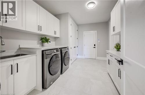 Main floor laundry, double closet, garage entry plus walk-in pantry to the right - 61 Schweitzer Street, Kitchener, ON 