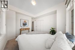 Carpeted bedroom featuring a closet and baseboards - 