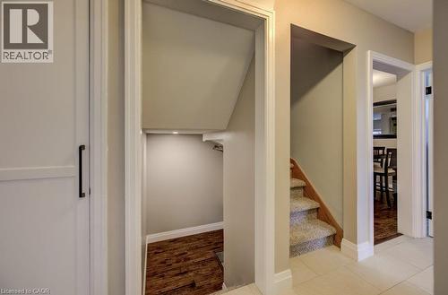 Recessed lighting, wood-finish flooring, under-stair storage, carpeted staircase, and tiled flooring - 37 Margaret Avenue N, Waterloo, ON 