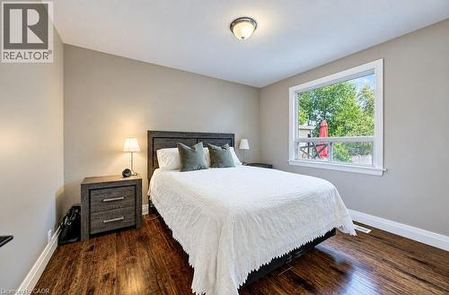 Wood-finish flooring, light neutral wall color, and a large window with white trim - 37 Margaret Avenue N, Waterloo, ON 