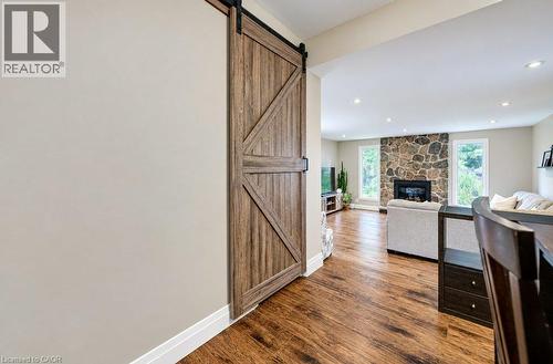 Wood-finish flooring, recessed lighting, and a stone-faced fireplace - 37 Margaret Avenue N, Waterloo, ON 