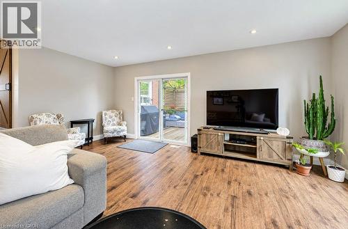 Wood-finish flooring, recessed lighting, and a sliding glass door providing outdoor access - 37 Margaret Avenue N, Waterloo, ON 