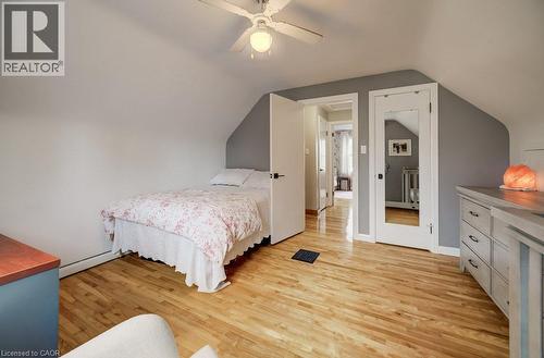 Hardwood flooring with natural finish, white ceiling fan with integrated lighting, white trim work, and neutral wall tones - 37 Margaret Avenue N, Waterloo, ON 