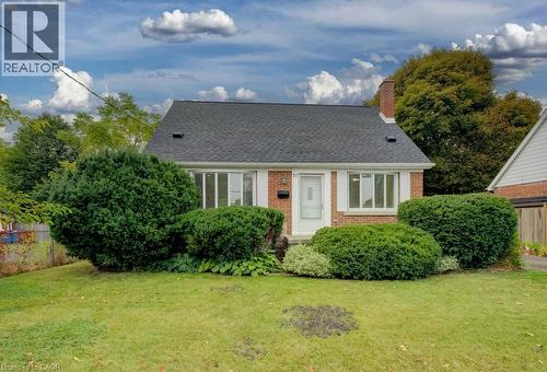 Brick exterior with a dark shingle roof and a prominent chimney - 37 Margaret Avenue N, Waterloo, ON 