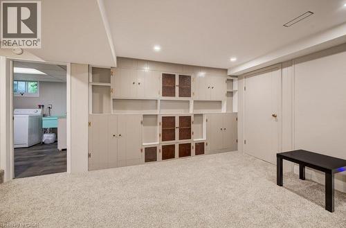 Built-in cabinetry with glass-front accents, recessed lighting, wall-to-wall carpeting, and a durable door - 37 Margaret Avenue N, Waterloo, ON 