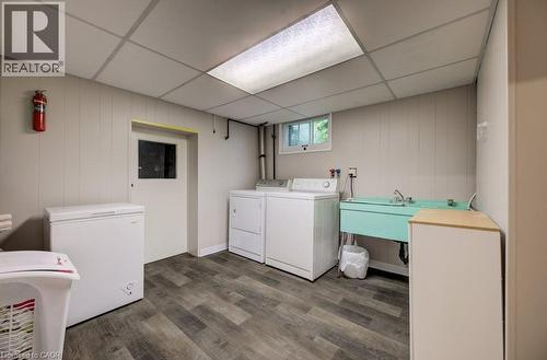 Laundry area featuring plank-style flooring, a utility sink, and a drop ceiling with recessed lighting - 37 Margaret Avenue N, Waterloo, ON 