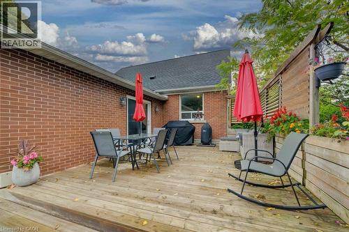 Expansive wood deck with a privacy fence, built-in planter boxes, and brick exterior - 37 Margaret Avenue N, Waterloo, ON 