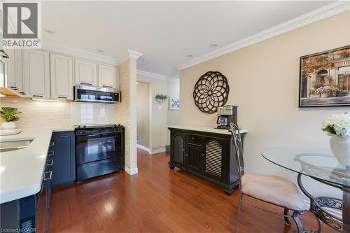 Wood-finish flooring, recessed lighting, and crown molding - 77 Yellow Birch Drive, Kitchener, ON 