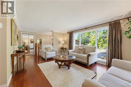 Expansive window offering abundant natural light, crown molding detailing, and hardwood flooring - 77 Yellow Birch Drive, Kitchener, ON 