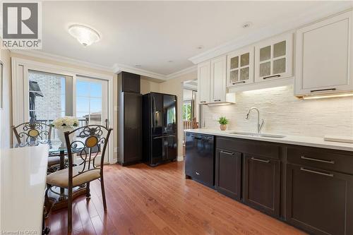 Hardwood flooring, two-tone cabinetry with under-cabinet lighting. - 77 Yellow Birch Drive, Kitchener, ON 