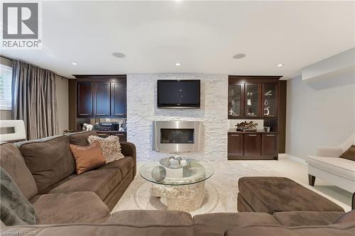 Feature wall with stacked stone facade and built-in fireplace - 77 Yellow Birch Drive, Kitchener, ON 