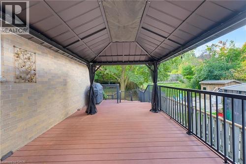 Expansive deck featuring composite decking, a permanent gazebo structure, and black aluminum railings. - 77 Yellow Birch Drive, Kitchener, ON 