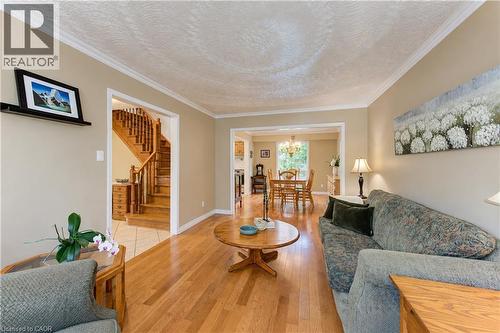 Hardwood flooring, crown molding, cased openings, and a wood staircase with balusters - 104 Deerwood Crescent, Kitchener, ON 