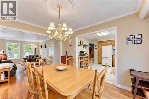 Hardwood-style flooring throughout, crown molding, and recessed ceiling medallion with chandelier - 104 Deerwood Crescent, Kitchener, ON 