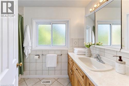 White tiled walls with decorative diamond accents - 104 Deerwood Crescent, Kitchener, ON 