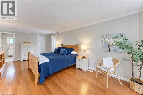 Wood-finish flooring, crown molding, and light gray wall paint - 104 Deerwood Crescent, Kitchener, ON 