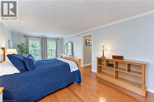 Hardwood flooring, crown molding, and a built-in shelving unit - 104 Deerwood Crescent, Kitchener, ON 
