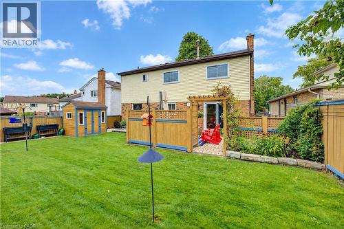 Expansive green lawn, wood pergola over brick patio, and garden shed - 104 Deerwood Crescent, Kitchener, ON 