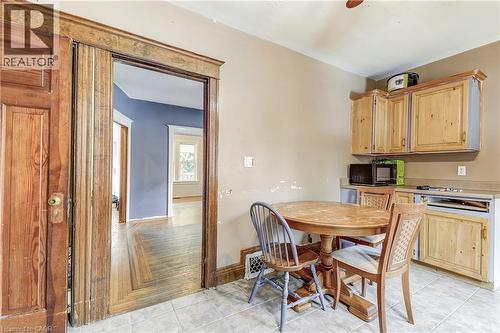 Tile flooring in kitchen space, wood-finish cabinetry, and a wood-finish countertop - 11 Elm Street, Hamilton, ON 