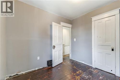 Interior room with two paneled doors, hardwood flooring, and light gray wall paint - 11 Elm Street, Hamilton, ON 