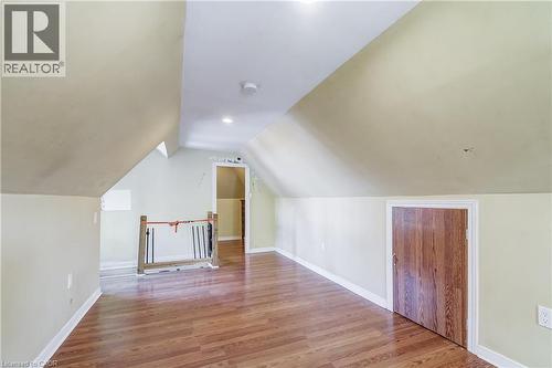 Wood-finish flooring, sloped ceilings, recessed lighting, and a wood-panel door - 11 Elm Street, Hamilton, ON 