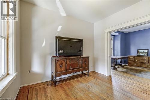 Hardwood flooring with decorative inlay, arched entryway, white trim, and light-colored walls - 11 Elm Street, Hamilton, ON 